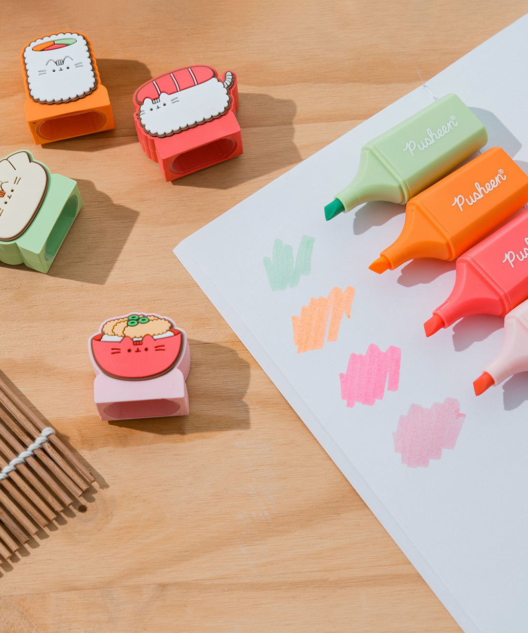 Pusheen highlighters with toppers removed to show the highlighter colors of each pen. The highlighter ink color matches the barrel color. Each highlighter is swatched on a white piece of paper.