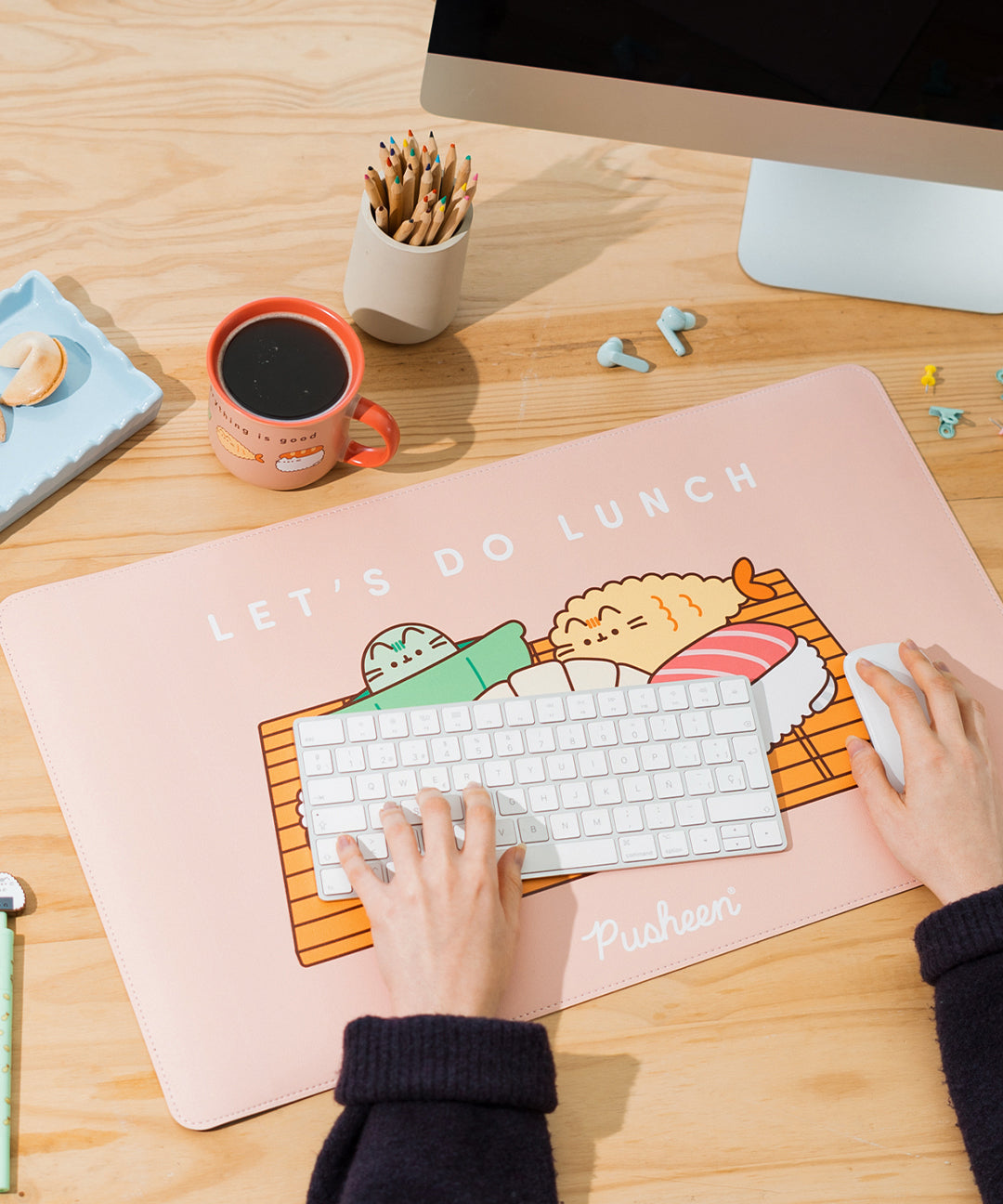 Model uses keyboard and mouse that are placed on top of the Pusheen Bento Desk Mat. The mat is large enough to house both items. 