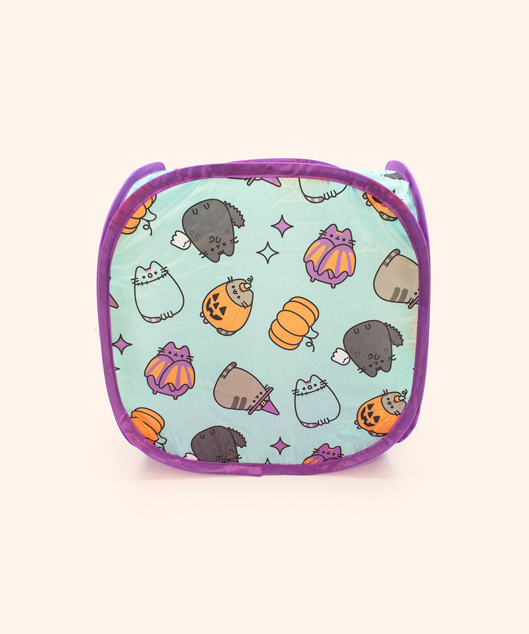 Side view of the Pet Halloween Collapsible Box showing the all over pattern on the pet toy. The Pusheen icons shown in the pattern are Scaredy Cat, Batsheen, Witch Pusheen, Pumpkin Pusheen, and Zombiesheen. Sparkles and pumpkin icons are mixed into the icons pattern.