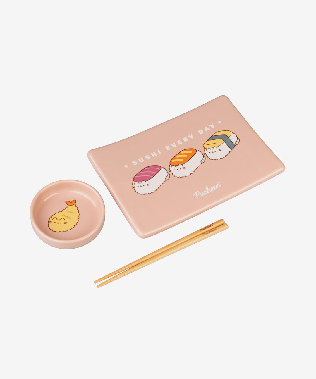 Pusheen Sushi Set contains one rectangular tray, one round dish, and a pair of chopsticks. The tray has three sushi graphics and the phrase "sushi every day". The soy sauce dish has a graphic of shrimp tempura pusheen.
