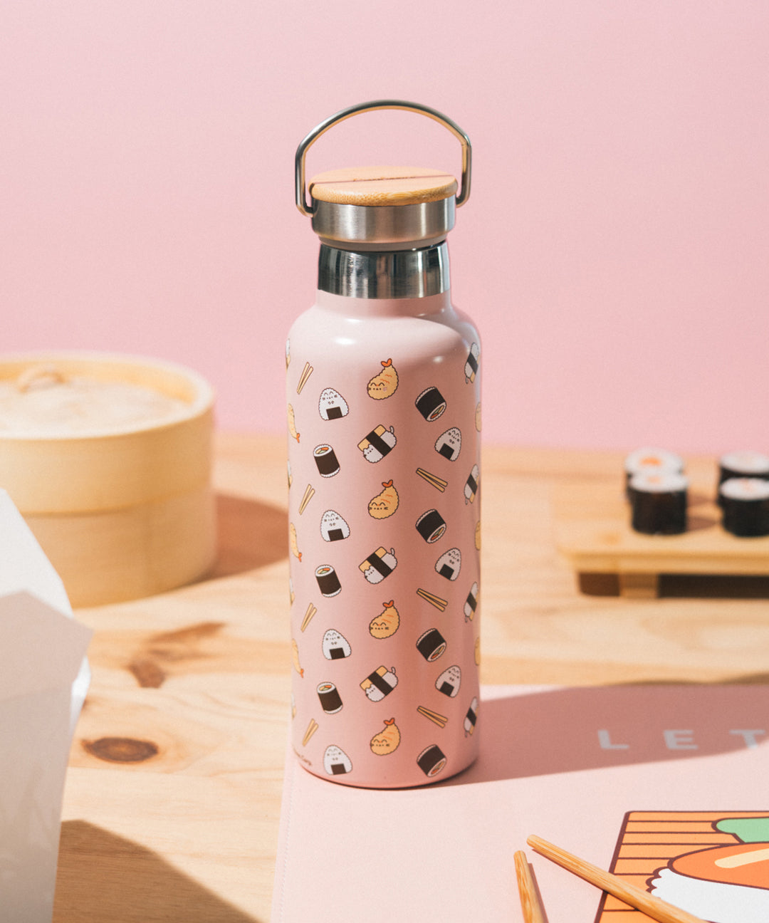 Pusheen Sushi Stainless Steel Water Bottle sits on a desktop. The exterior includes a repeating printed pattern of Pusheen as shrimp tempura and onigiri. Throughout the pattern are sushi roll and chopsticks icons.