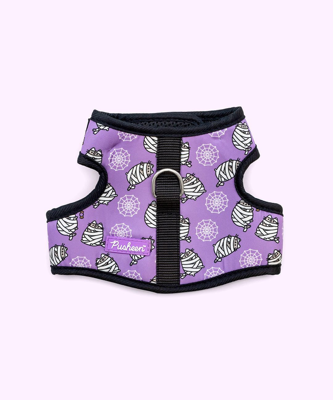 Front view of the Pusheen Pet Halloween Mummy Harness. The black and purple velcro harness has an all over print of spider weds and Pusheen as a mummy.