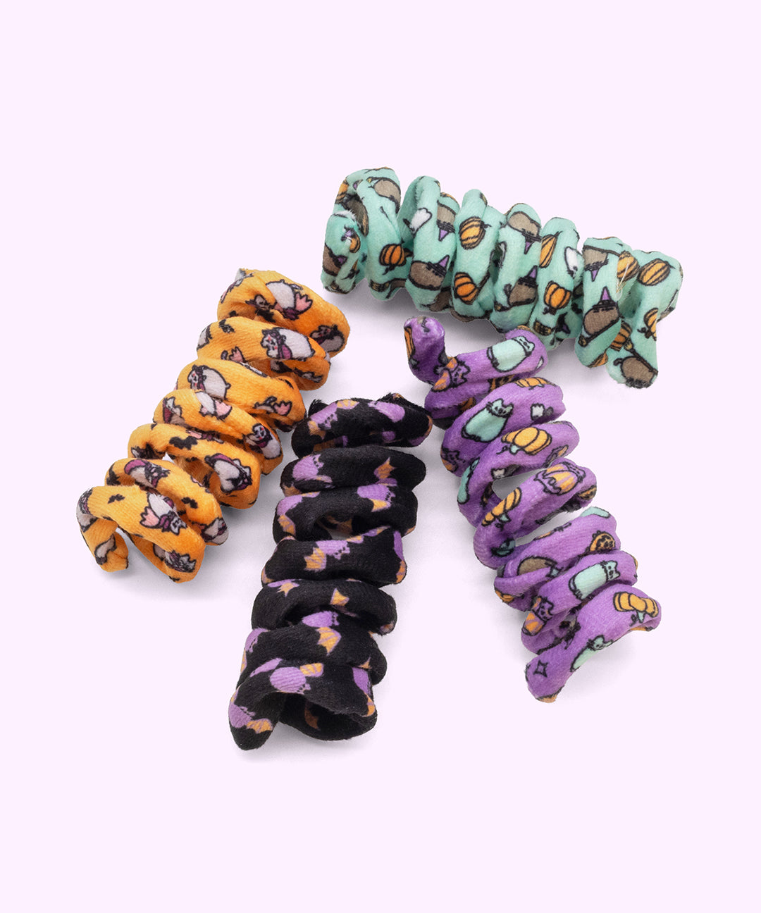 Pusheen Halloween Pet Spiral Toys 4-Pack includes orange, purple, black, and mint green spiral toys with all over patterns of Pusheen and Halloween elements. 
