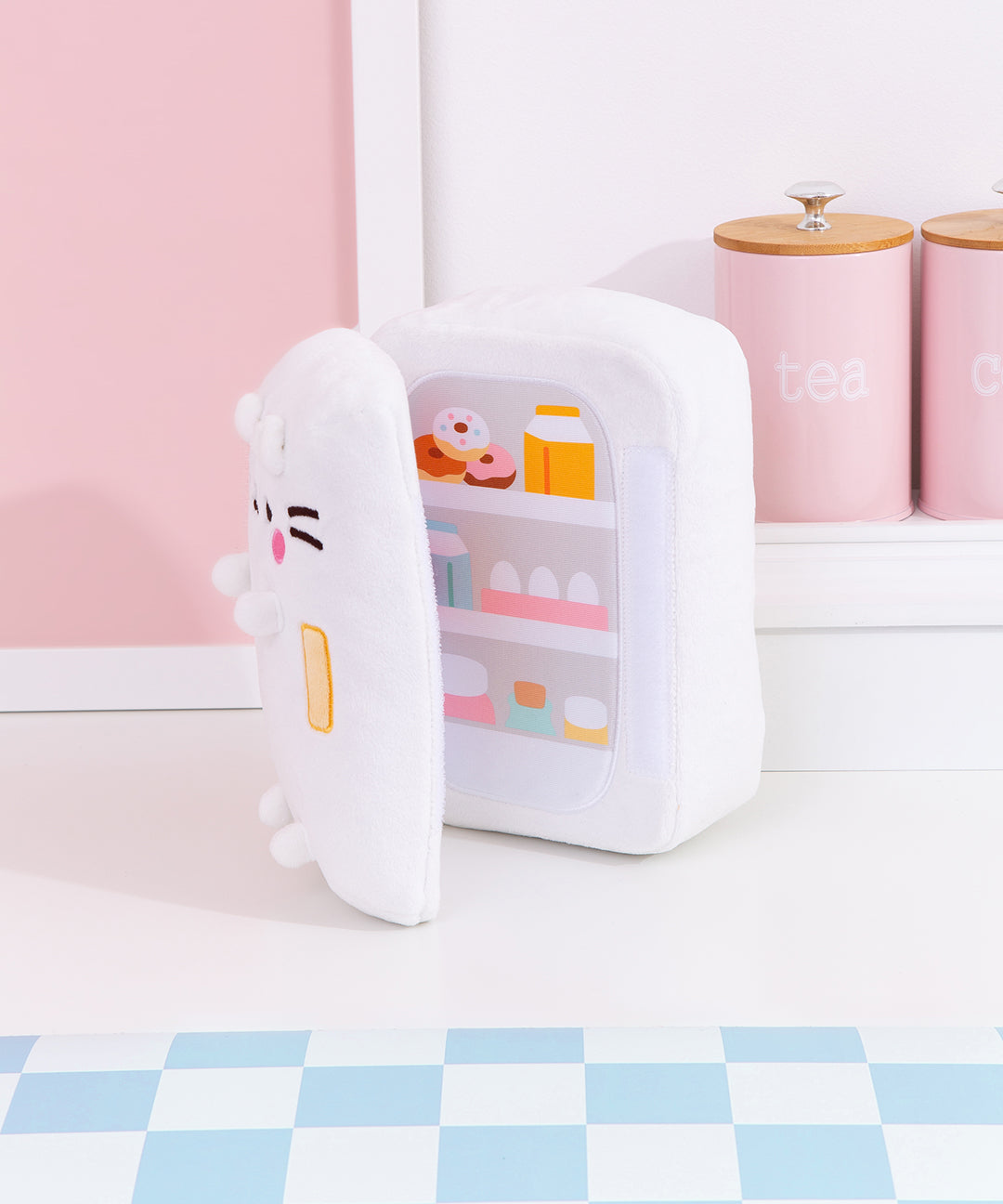 Partial interior view of the fridge plush. The plush opens to reveal a printed stocked fridge of Pusheen's favorite snacks. Included in the interior prink are milks, donuts, eggs, and more!