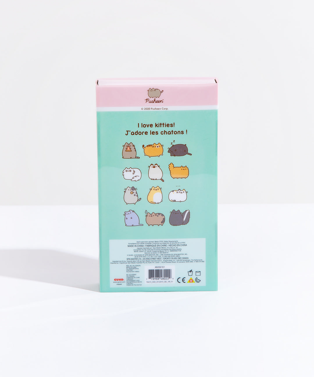 The back of the Pusheen I love Kitties Plush Collectors Set in its original packaging, standing upright in front of a white background. The back features the original comic the plush set is based on, with four rows of three miscellaneous cats, starting with Pusheen holding a pizza and ending with a skunk, which the cats around it react to its smell. The copyright information is noted in small text in a block underneath the comic.