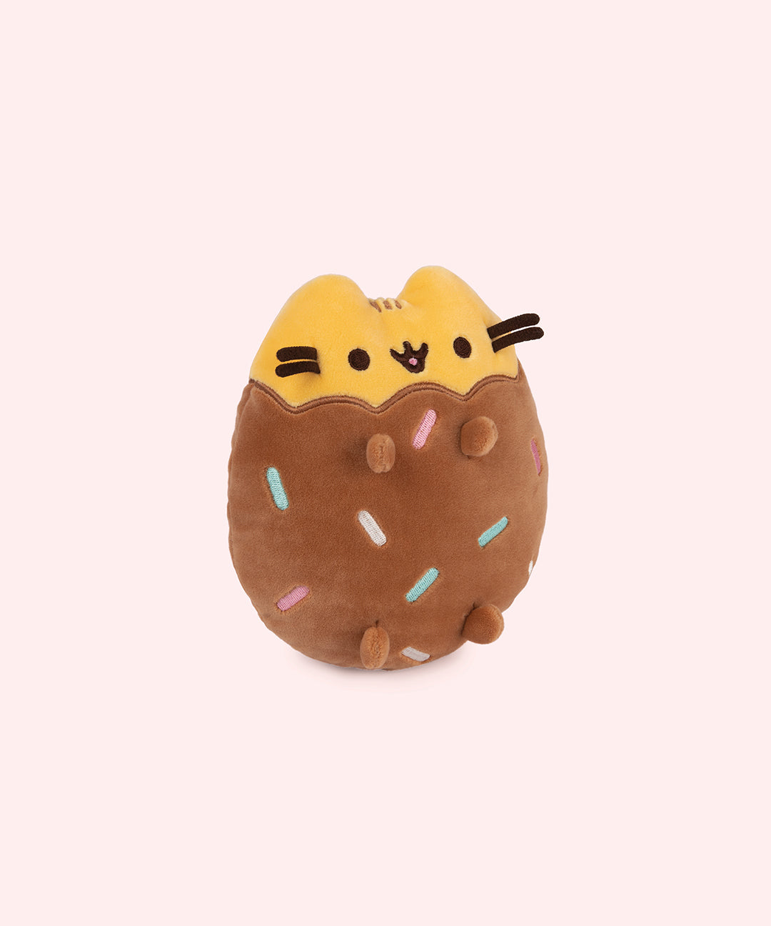 Right quarter view of Chocolate Dipped Cookie Squisheen. In the brown lower portion of the plush there is a scalloped edge that meets the yellow portion of Pusheen’s head and ears. 